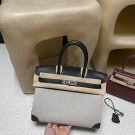 30cm Birkin (Fabric & Swift Leather) – Color: 89 Noir (with Silver Hardware) The fabric material creates a youthful vibe and is lighter than full-leather versions, which is its key feature.