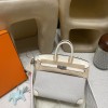 Hermès Birkin 25 (Triomphe H Canvas & Swift Leather) – Color: I2/Nata (with Silver Hardware) – A soft cream-white hue – This model is characterized by a combination of high-quality Swift leather and lightweight canvas. The natural cream-white color create
