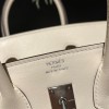 Hermès Birkin 25 (Triomphe H Canvas & Swift Leather) – Color: I2/Nata (with Silver Hardware) – A soft cream-white hue – This model is characterized by a combination of high-quality Swift leather and lightweight canvas. The natural cream-white color create